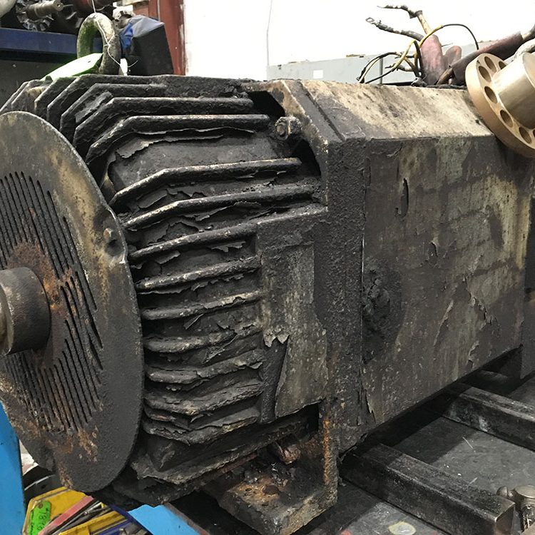 Dirty industrial DC motor in Duke Electric repair shop